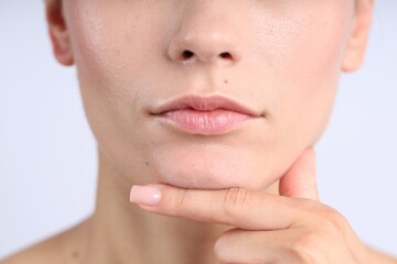 Woman with normal skin on light background, closeup