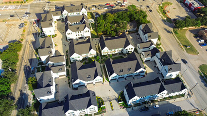 Three-story townhomes in gated layout between Cooper Street, Main Street, and Vista Lane in Arlington, Texas. Courtyard design and walkable paths enhance residential appeal near college campus