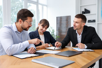 Couple having meeting with business consultant at table in office