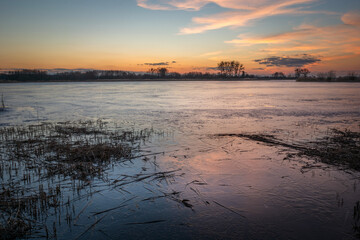 View of the frozen lake after sunset