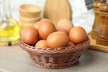 Raw chicken eggs on wooden counter, closeup