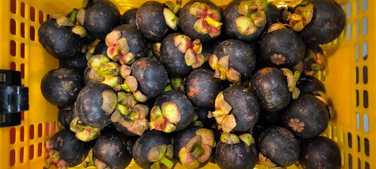 Mangosteen in a yellow basket