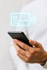 Hand Holding Smartphone with Contactless Payment Card Concept in Modern Lifestyle and Financial Technology