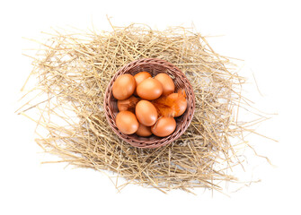 Chicken eggs in basket and nest isolated on white, top view