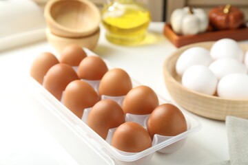 Raw chicken eggs on white table, closeup
