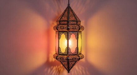 A decorative, ornate lantern hangs, casting warm light and shadows on a wall.