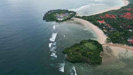 Aerial drone view showcasing two small tropical islets off the coastline, featuring colorful amusement rides, sandy beaches, and lush greenery surrounded by turquoise waters. - Powered by Adobe