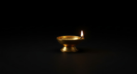 Minimalist Traditional Brass Diya Oil Lamp Lit Against Dark Background Symbolizing Light Hope and Prosperity for Diwali Festival Deepavali Celebration and Spiritual Prayer Rituals