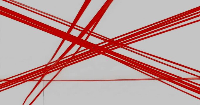 Abstract red lines intersecting on a white background, creating dynamic visuals