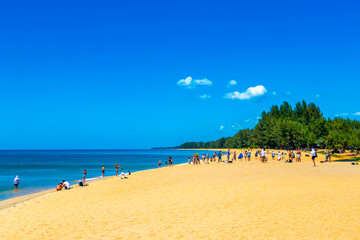 Tropical Mai Khao Naiyang Beach people tourists Phuket island Thailand.