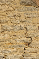 Traditional dry stone wall texture showing rustic aged masonry with natural rough surface and weathered mortar background