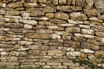 Dry stone wall texture showing weathering, a weathered stone pattern, and old masonry construction