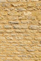 Old rough cut stone wall background showing natural texture, construction, and durable material