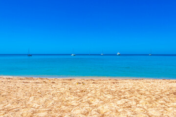 Tropical turquoise blue Mai Khao Naiyang Beach Phuket island Thailand.