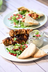 plate with delicious chicken and kebab