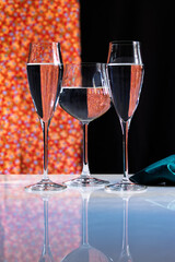 still life three glasses with water on red and black background