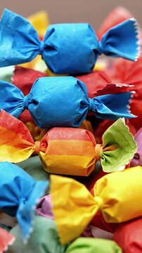 A pile of salt water taffy in assorted, brightly colored wrappers.