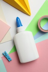 Glue and other stationery on white background, flat lay