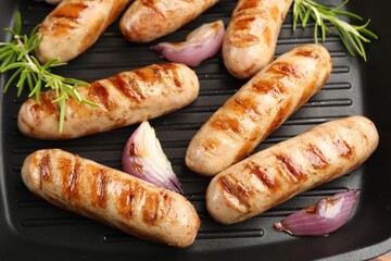 Pan with grilled sausages and spices, top view