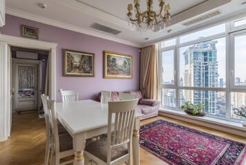 Elegant dining room with city view, paintings, and chandelier, bathed in natural light