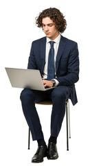 Young man with curly hair in a suit sits on a chair and uses a laptop, looking down at the screen.