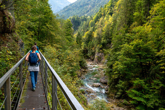 Hiking Group On Spectacular Trail Triftsteig Through Canyon Tiefenbachklamm With Brandenburger Ache In Tyrol, Austria