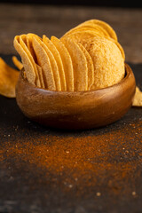 crispy potato chips fried in oil and sprinkled with spices of dried red sweet pepper, a large number of delicious salty sweet chips with aromatic spices