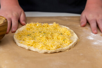 cheese tortilla made of yeast dough and grated cheese, thinly rolled yeast dough sprinkled with hard grated cheese
