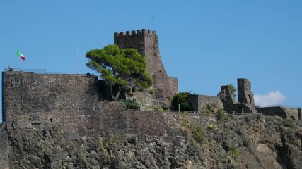 Castello di Aci Castello ancient Norman fortress on lava rock cliff above the Ionian Sea in Sicily Italy historic medieval castle and coastal landscape - Powered by Adobe