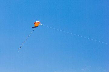 Colorful Kite Flying High in the Clear Blue Sky