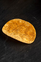 one delicious salty sweet pepper-flavored chips with aromatic spices, close up