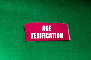 Age Verification message written on ripped torn pink paper piece on green background. Conceptual...