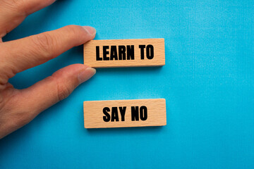 Learn to Say No message written on wooden blocks on blue background. Conceptual Learn to Say No symbol. Copy space.