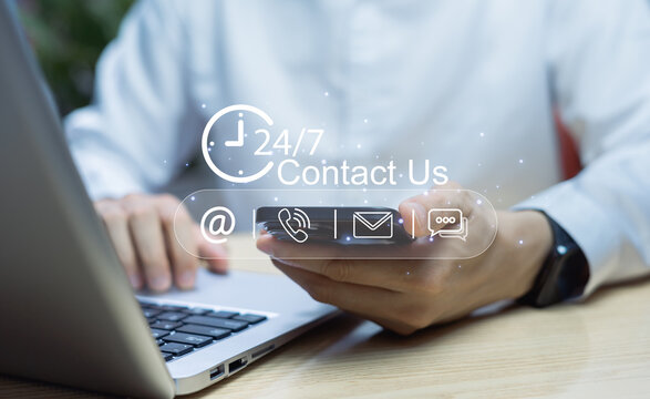 Technology communication and customer support concept with businessman using mobile chat and laptop, showing virtual contact icons for online network and hotline services
