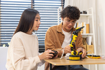 Young couple building robotic arm at home
