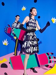 Stylish young adults posing in colorful outfits with playful props.