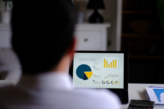 Thoughtful businessman working at laptop analyzing financial data