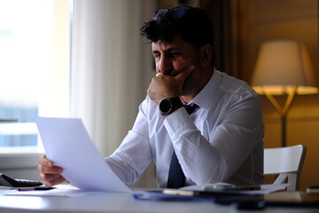 Obraz premium bored, thoughtful and worried businessman checking paperwork about contracts, executions, debts and company files