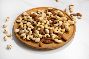 Assortment on nuts on wooden plate healthy food