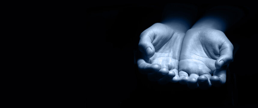 Asking hands on black backdrop