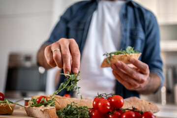 Man preparing healthy bruschetta for a delicious snack