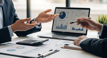 Business professionals collaborating on financial analysis, reviewing market data and strategic planning reports on laptop