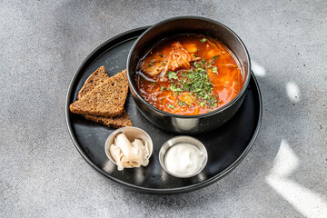 Traditional Ukrainian borscht with sour cream and rye bread