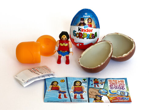 Italy &ndash; October 4, 2025: Kinder Surprise eggs by Ferrero with Wonder Woman Figurine. 2025 Edition featuring DC Playmobil Superhero characters