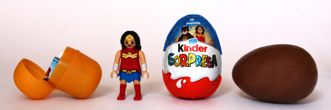 Italy &ndash; October 4, 2025: Kinder Surprise eggs by Ferrero with Wonder Woman Figurine. 2025 Edition featuring DC Playmobil Superhero characters