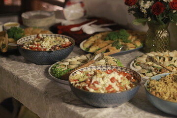 Assorted Salads and Food in Bowls and Plates on Table