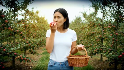 Apple Orchard Harvest: Woman Enjoying Fresh Fruit in Rural Setting