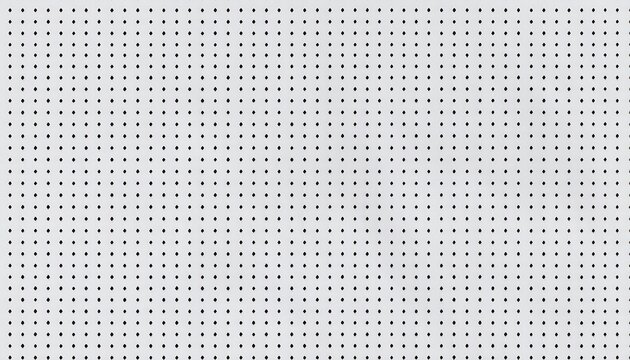 A close-up of a white pegboard, featuring evenly spaced holes