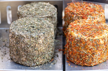 Sfizioso matured italian herbs  cheese high-quality, flavorful Italian cheese from sheeps pecora milk on weekle market in Gorgonzola, Lombardy, Italy