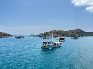 Discover serenity sailing in Komodo National Park, Indonesia, turquoise waters and islands beckon adventurers on a luxury boat trip